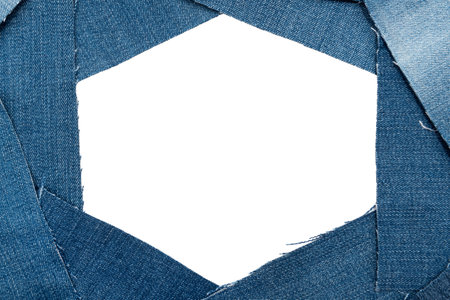 Hole in denim on a white background. Ripped jeansの写真素材