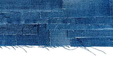 Piece of torn denim on a white background. Denim textureの写真素材