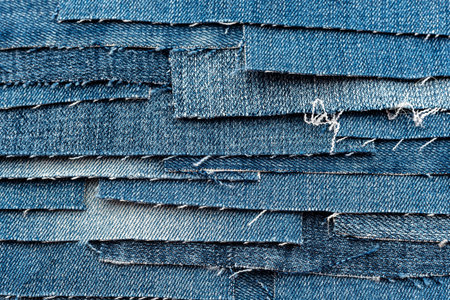 Texture from torn pieces of denim. Jeans texture. Material for sewing clothesの写真素材