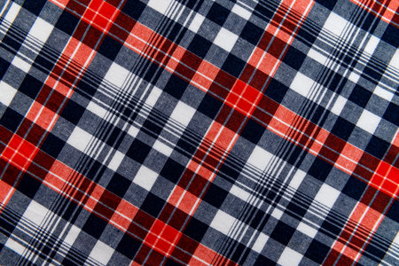 The texture of linen fabric in a large cage of blue, red, yellow and white. Checkered fabric