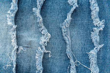 Texture from torn pieces of denim. Jeans texture. Material for sewing clothesの写真素材