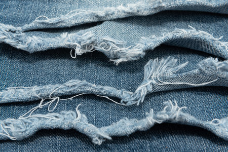 Texture from torn pieces of denim. Jeans texture. Material for sewing clothesの写真素材
