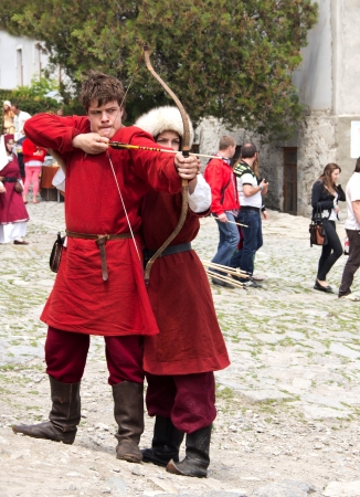 KAMYANETS-PODILSKY- JUNE 2: Shooting archer during Forpost (The Outpost) Festival of Medieval Culture on June 2, Ukraineのeditorial素材