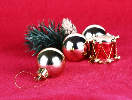 Golden Christmas  balls and toy drum on red backgroundの写真素材