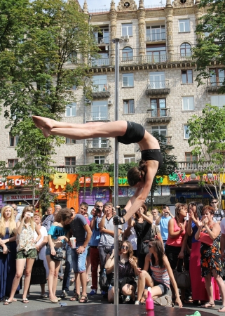 KIEV, UKRAINE - JUNE 30: Unidentified  pole dancer woman and spectators during Youth Day  in Kiev, Ukraine on June 30, 2013のeditorial素材