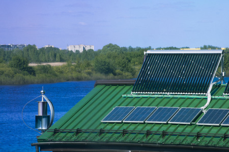 Solar battery and wind turbine on the roofの写真素材