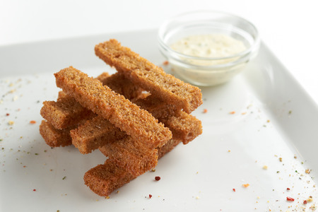Crispy fried toast sticks with souce. White plate.の写真素材