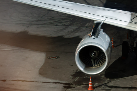 Aircraft wing, turbine and chassis closeup. Airplane loading at the airport Domodedovo at night.の写真素材