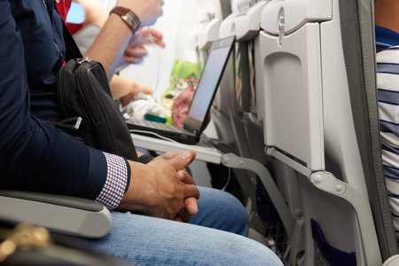 A man is nervous during the flight. Hands crossed.の写真素材