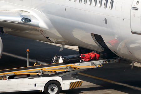 Loading suitcases of tourists in the plane.の写真素材