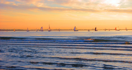 The Gold sky, blue sea and regatta. Beautiful idyllic picture. Tallinn.の写真素材
