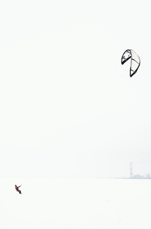 Snowboarder riding a kiteの写真素材