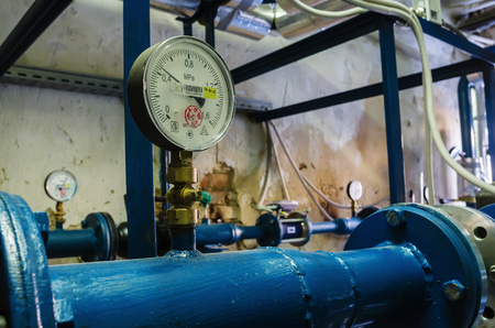 Heat-regulating equipment in the basement of a heated building / Photo taken in Russia. Heating systems for apartment houses and heat metersのeditorial素材