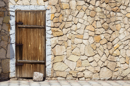 Wooden door in the stone wall / Photo taken in Russia, in the city of Orenburgの写真素材