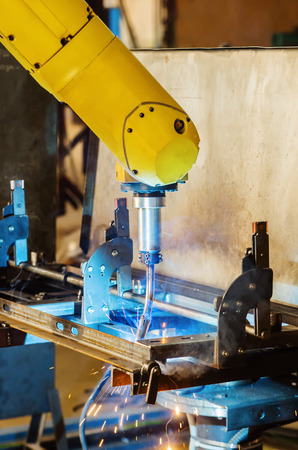 Welding robot in operation / Photo taken in Russia, in factory premisesの写真素材