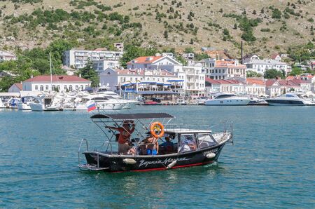 Pleasure boat in the sea bay. Russia, Republic of Crimea, Balaclava. 11.06.2018: Pleasure boat with tourists in Balaklava Bayのeditorial素材