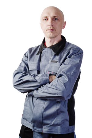 Man in working clothes. Portrait of a middle-aged man, European appearance, in a working overalls. Isolated on white backgroundの写真素材