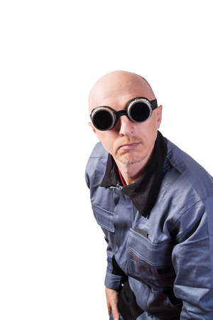 A man in working clothes, in dark gas-welding glasses. A man of middle age, European appearance, in a working overalls. Isolated on white backgroundの素材 [FY310126134829]