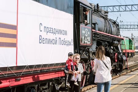 Steam locomotive Series L on the station platform. Orenburg, Russia - May, 8, 2019: Departure of the...