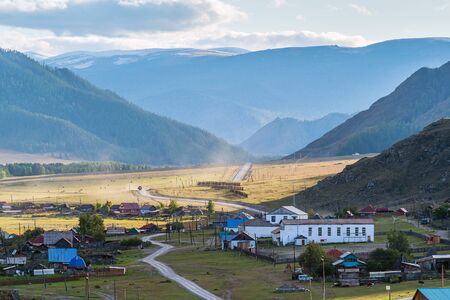 Rural autumn mountain landscape with a village. Russia, mountain Altai, Ongudaysky district, the...