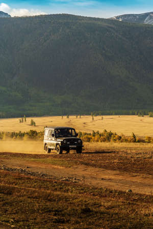 Altai Republic, Russia - September, 18, 2019: UAZ SUV driving on the Kurai steppe in the early...