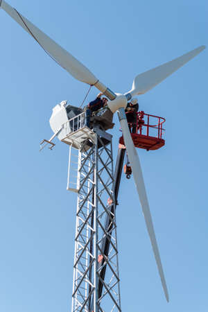 Orenburg, Russia - May, 26, 2020: Installation work on a wind turbine using an aerial platform