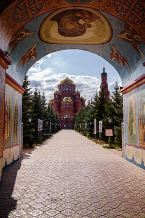 Holy Trinity Simeon Monastery of Mercy, Saraktash, Russia - October, 1, 2020: Cathedral of the Life-Giving Trinity, view through the arch of the gates of the Church of the Monk Martyr Vadim of Persiaのeditorial素材