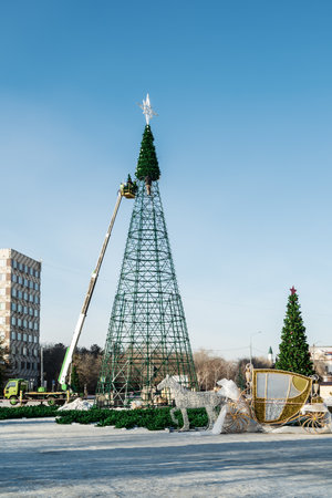 Assembling the main city Christmas tree in the city square.の写真素材