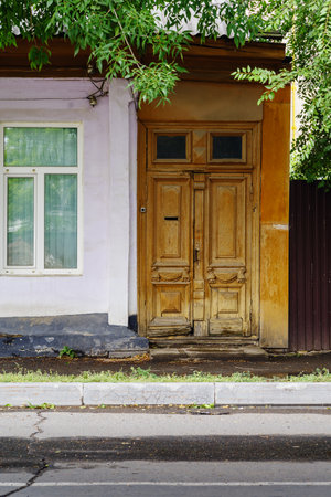 Window and old carved wooden door, a fragment of an old building. The picture was taken in Russia, in the city of Orenburgの写真素材
