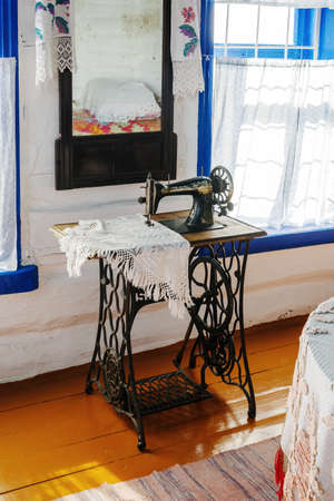 Arkaim, Russia - August, 24, 2021: Old mechanical sewing machine with foot drive by Singer firm in...