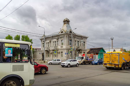 Orenburg, Russia - September, 04, 2021: An old two-story mansion with a corner turret on the roof. Traffic. Crossroads of Rybakovskaya and Proletarskaya streetsのeditorial素材