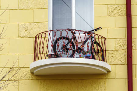 Bicycle on the balcony of a multi-storey building. The picture was taken in Russia, in the city of Orenburgの写真素材