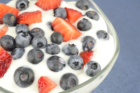 Yogurt with fresh berries on a blurry backgroundの写真素材