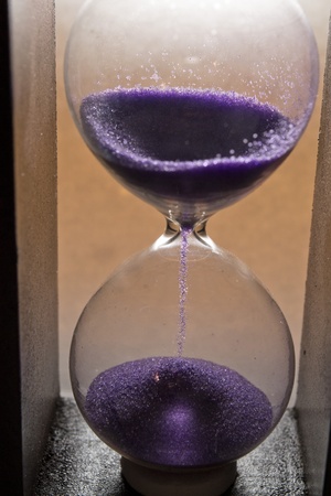 hourglass with purple sandの写真素材