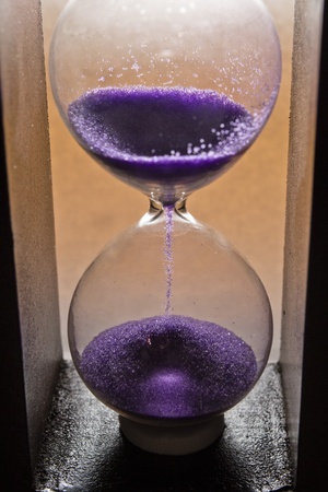 hourglass with purple sandの写真素材