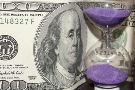 hundred dollars against the hourglassの写真素材