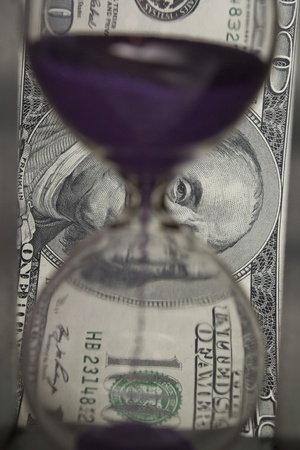 hundred dollars against the hourglassの写真素材