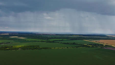 Rain falling in the distance from above. atmospheric phenomenon.の写真素材