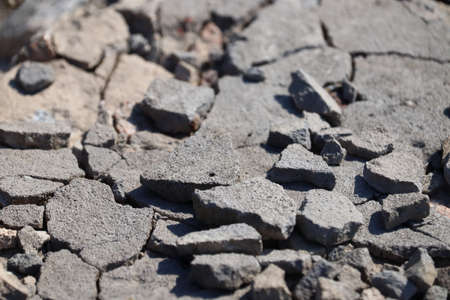 Broken asphalt close-up. bad road. Stones on the way.の写真素材