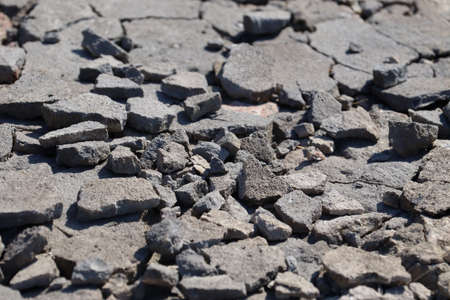 Broken asphalt close-up. bad road. Stones on the way.の写真素材