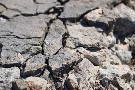 Broken asphalt close-up. bad road. Stones on the way.の写真素材