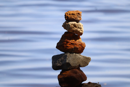 Stones stacked on top of each other on the background of the river.の写真素材