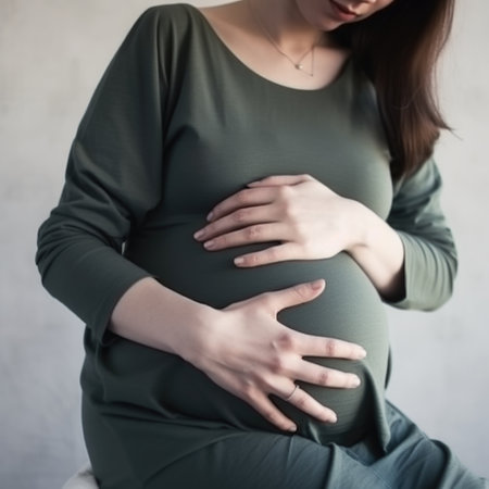 A pregnant woman holds her stomach. Waiting for the birth of a child. AI generative.の素材