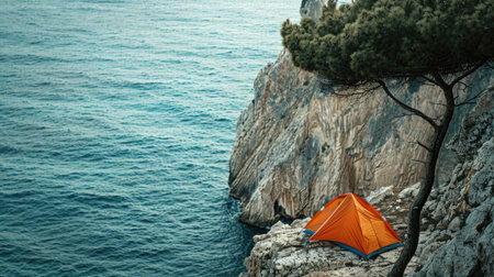Orange tourist tent on the edge of a cliff by the sea. Travel and tourism. AI generative.の素材
