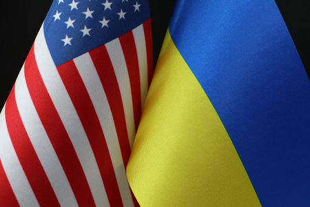 Close-up of the American and Ukrainian flags waving together. A symbol of solidarity.の写真素材