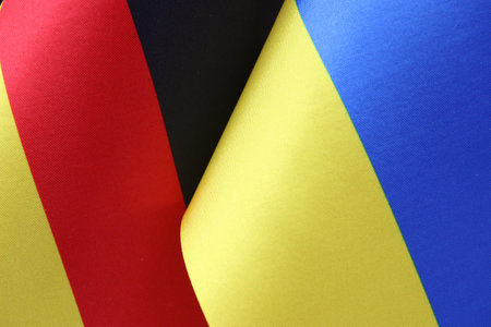 The German and Ukrainian flags waving together. A symbol of cooperation.の写真素材