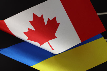 Close-up of the Ukrainian and Canadian flags. A diplomatic partnership.の写真素材