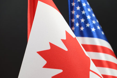 The Canadian and American flags waving together. A symbol of international cooperation.の写真素材