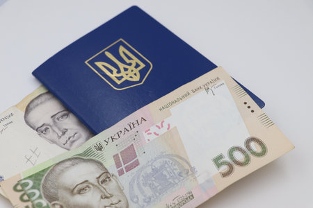 A Ukrainian passport placed on top of several 500 UAH bills.の写真素材