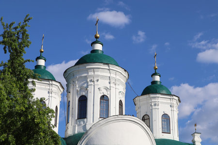 A historic church with green domes and golden crosses in Kyiv.の写真素材